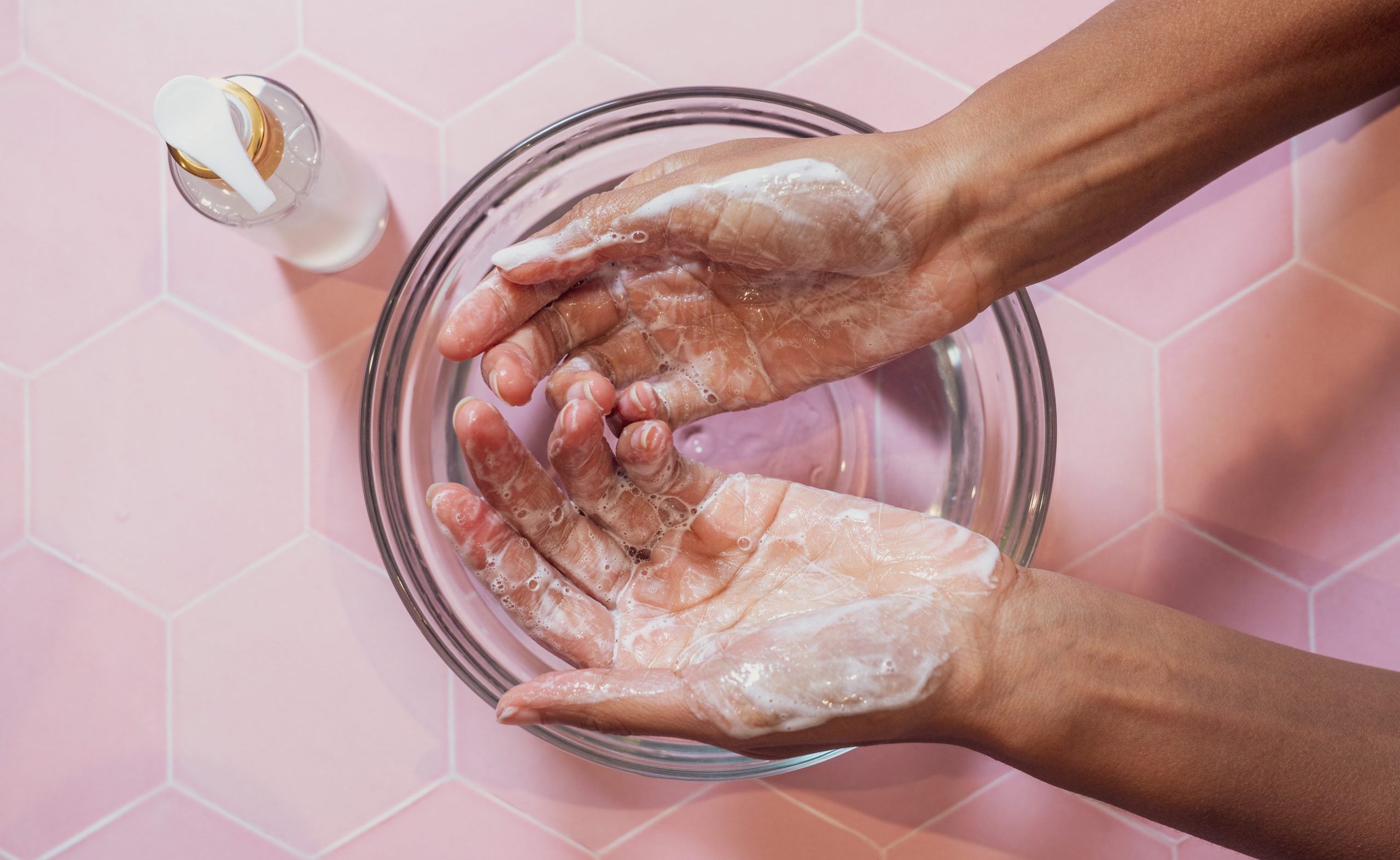 Hands washing with soap in bowl